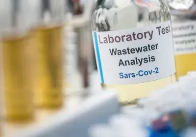 liquid-containing tube labeled Laboratory Test Wastewater Sample SARS-CoV-2